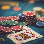 a close-up of poker chips and playing cards on a casino table