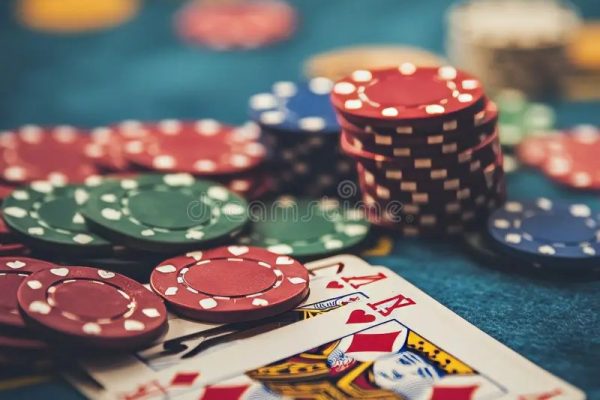 a close-up of poker chips and playing cards on a casino table